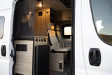 Explore your next RV rental: modern camper van interior with swivel seats, galley, and storage.