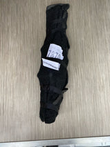 A dark, strapped item with a '7870' label on a wood-grain floor, likely RV rental equipment secured for travel.
