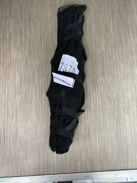 A dark, strapped item with a '7870' label on a wood-grain floor, likely RV rental equipment secured for travel.