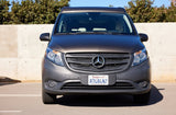 Front view of a dark-colored Mercedes-Benz van, ideal for RV rental adventures, parked on asphalt.