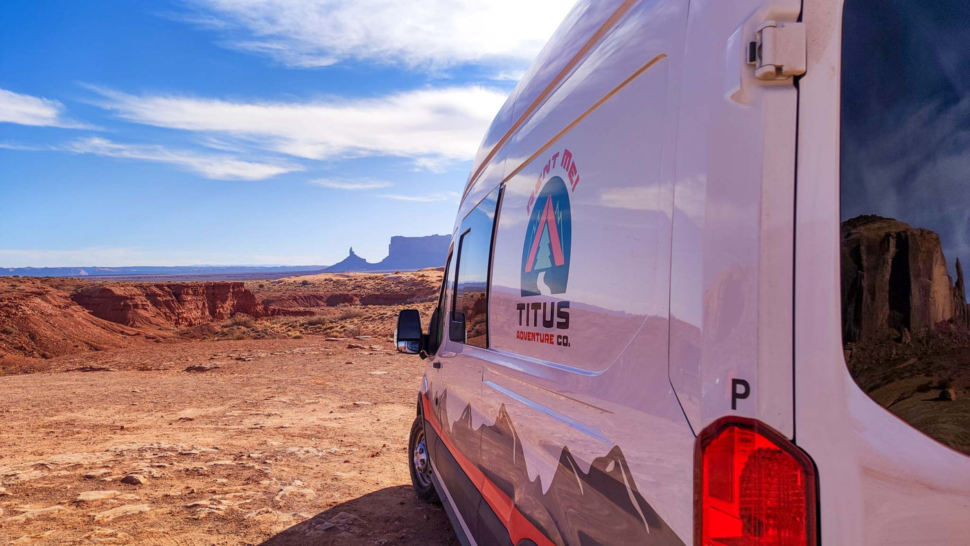  revealing a compact kitchen and seating. Perfect for van life travel!|RV rental adventure: Dirt road leads to a majestic snow-capped mountain through a pine forest — photo 7