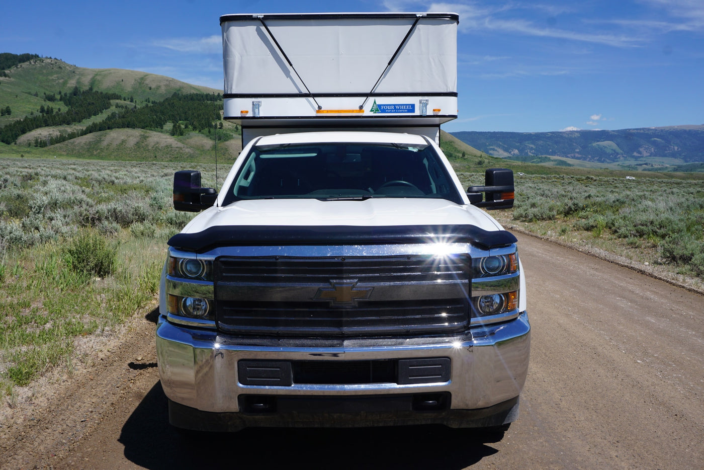  parked on a dirt road amidst green hills. Perfect for an **RV rental** adventure.|Inside a clean RV rental — photo 3