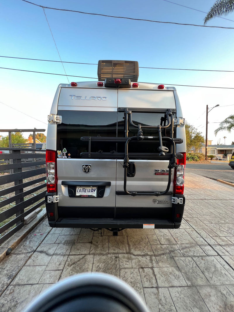  is parked at a sunny beach with its side door open.|An RV rental — photo 7