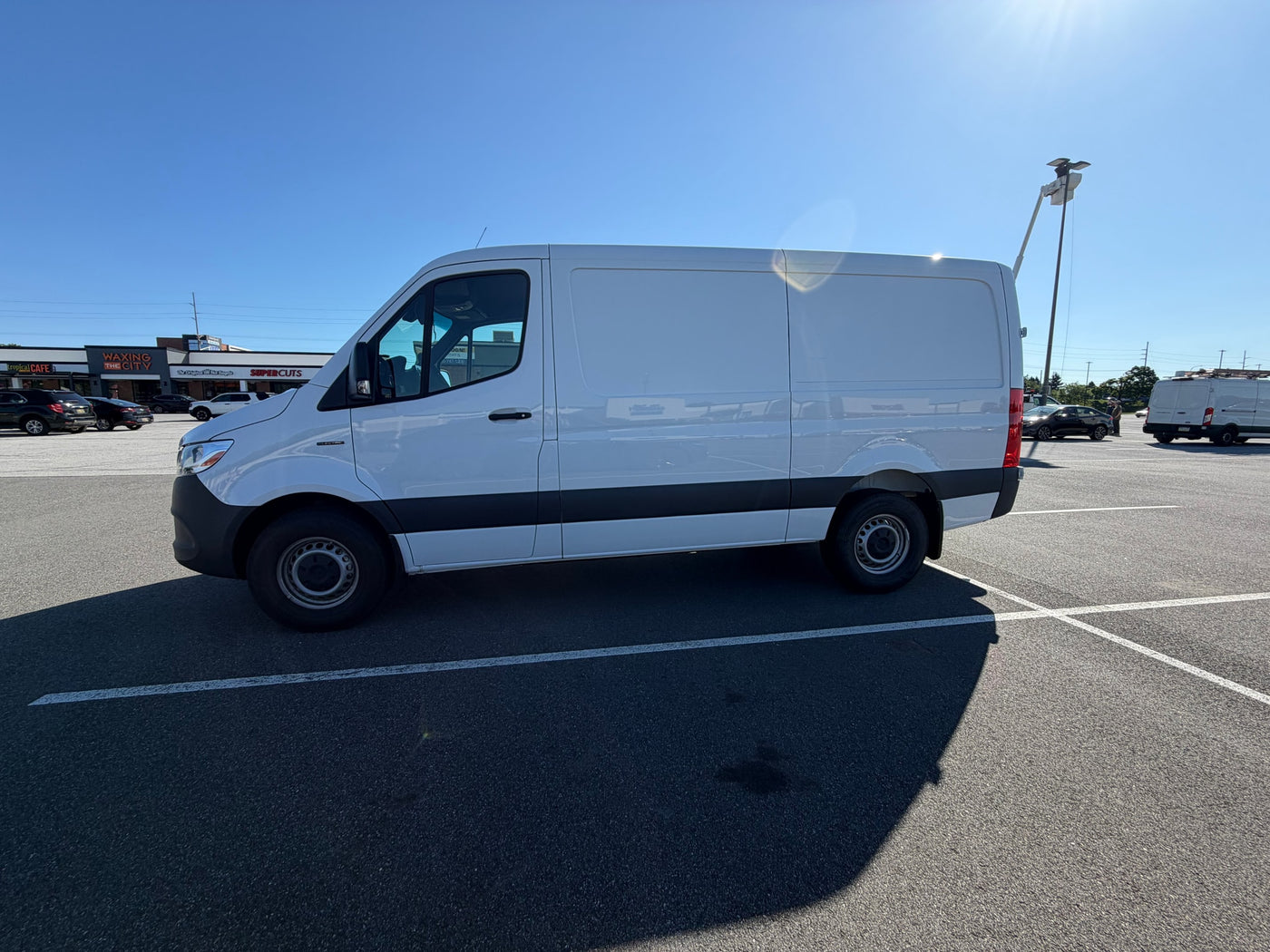  and front seats on a sunny day.|RV rental cargo van interior: cot — photo 10