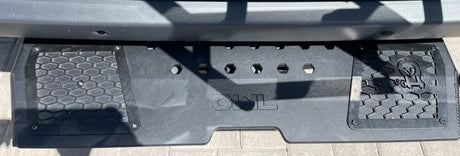 RV rental's black Owl Vans rear step plate with honeycomb texture, hex tool mounts, and owl logo.