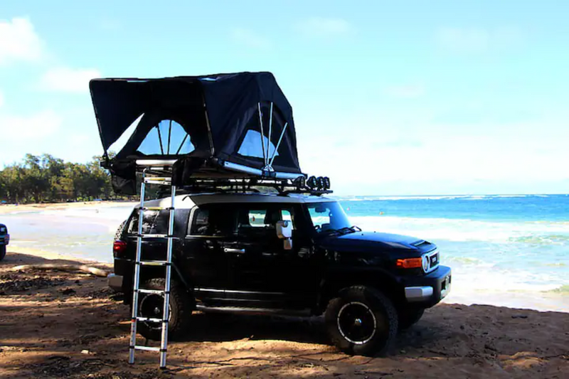 Explore with this RV rental: A Toyota FJ Cruiser with a rooftop tent ready for beach camping. — photo 2
