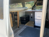 Van conversion for rv rental: Features a comfy bed, portable fridge, catalytic heater, and storage, ready for adventure.