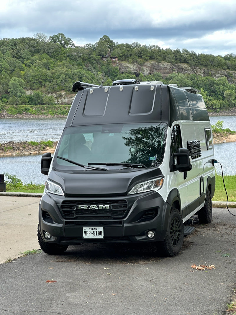 This rv rental camper van is parked by a lake, plugged in and ready for adventure. Enjoy nature in this converted Ram ProMaster. — photo 15