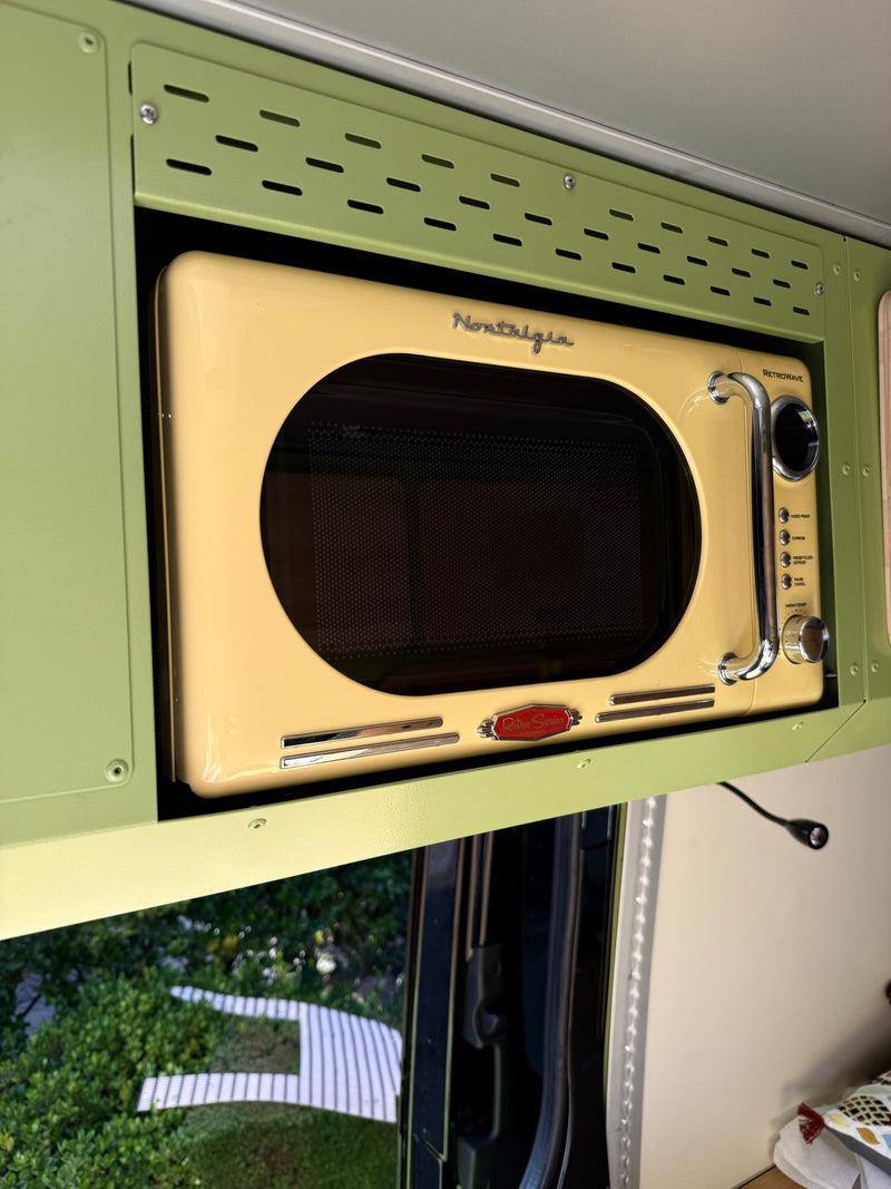  and comfortable white seating create a cozy mobile living space.|Explore this modern RV rental interior: a custom camper van featuring a functional kitchen — photo 14