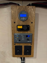 RV rental power system controls: Victron battery monitor (13.5V), Eberspächer heater, inverter/charger, & light dimmers.