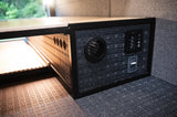 RV rental storage unit with fan, control panel, & USB port. Textured interior for durable camper van travel.