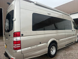 This tan Mercedes Sprinter rv rental camper van features an awning & tinted windows, ready for adventure.