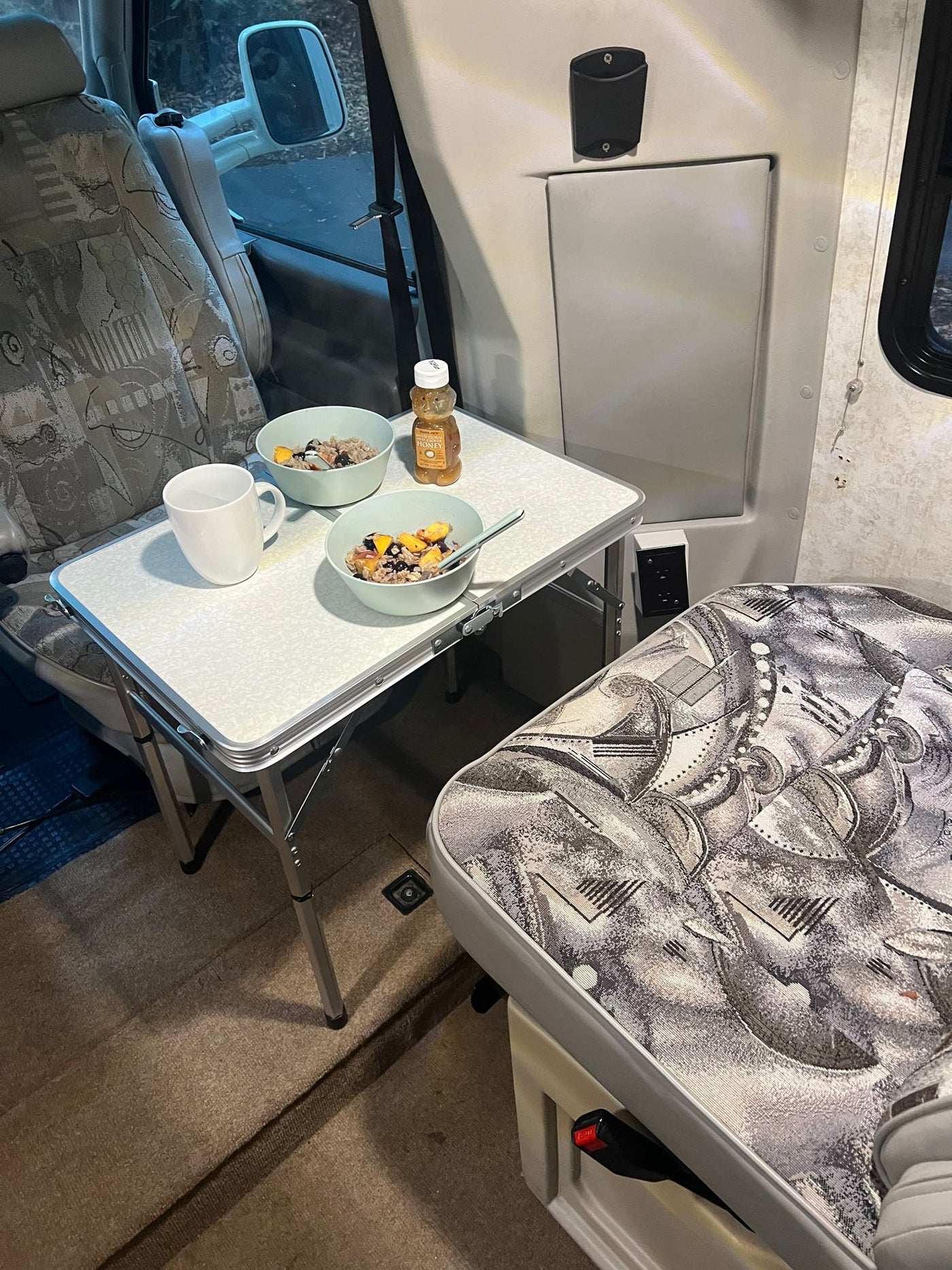 and ample storage for trips.|RV rental interior: compact kitchen with microwave/fridge — photo 12