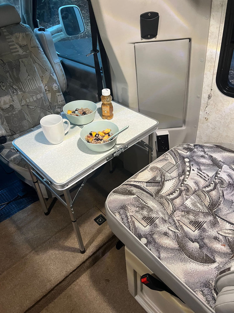  and ample storage for trips.|RV rental interior: compact kitchen with microwave/fridge — photo 12