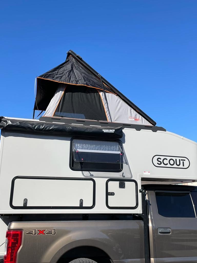  ready for a forest getaway.|Scout truck camper RV rental with rooftop tent and ladder on a pickup. Perfect for your next adventure.|This RV rental offers a cozy — photo 8