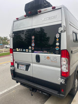 Silver Winnebago Solis Pocket **rv rental** rear, adorned with travel stickers, hinting at many road trip adventures.