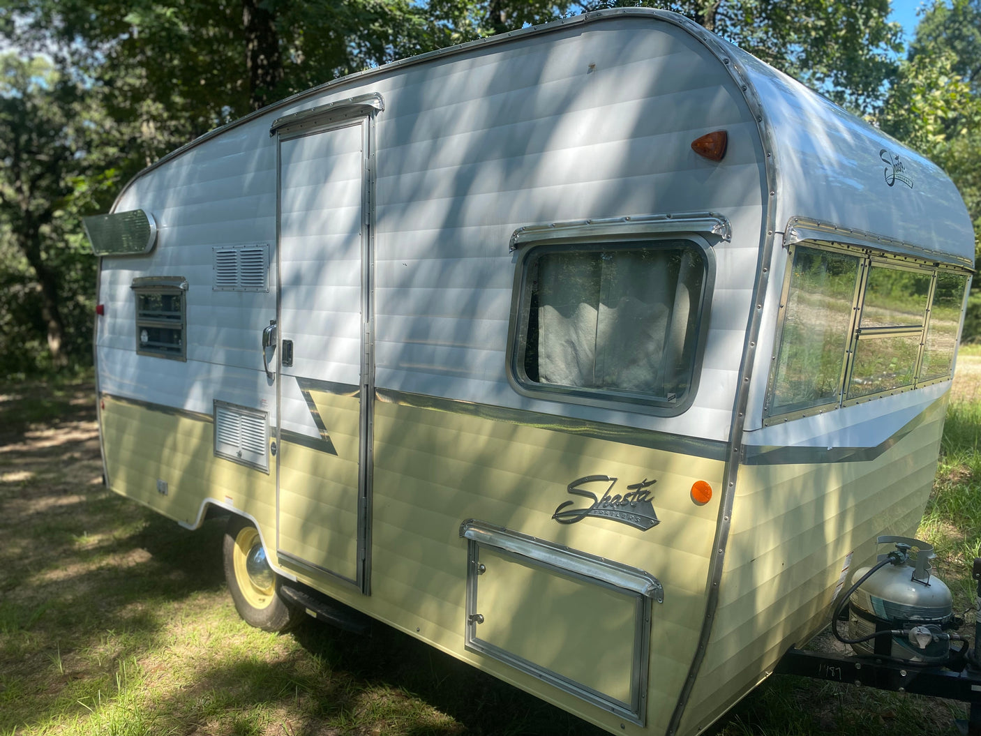 Eye-catching white and cream vintage Shasta travel trailer, available for RV rental. Ideal for classic camping.
