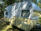 Eye-catching white and cream vintage Shasta travel trailer, available for RV rental. Ideal for classic camping.