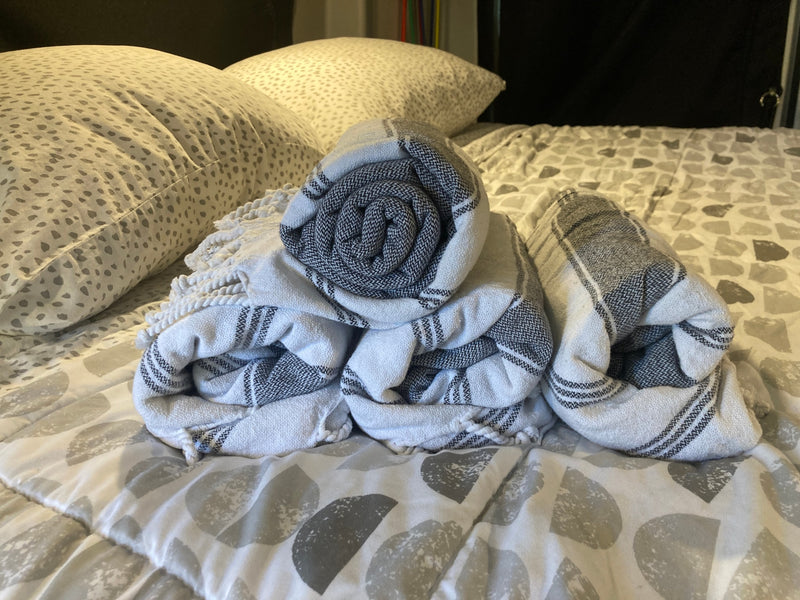 Plush pillows and rolled, striped blankets on patterned bedding in an RV rental. A cozy sleep setup. — photo 20