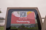 This RV rental sticker on a vehicle's back window displays a QR code to "RENT ME ON Outdoorsy" for your next trip.