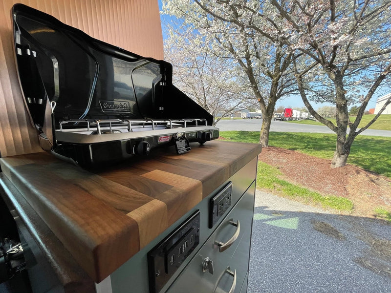  and wooden accents.|RV rental: Open refrigerator revealing compact interior — photo 3