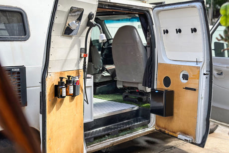 This RV rental camper van features a clever outdoor shower with soap and smart storage for road trips.
