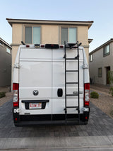 White Ram ProMaster 2500 rv rental van with a ladder & MA license plate (4ZAW 35), parked in a residential driveway.