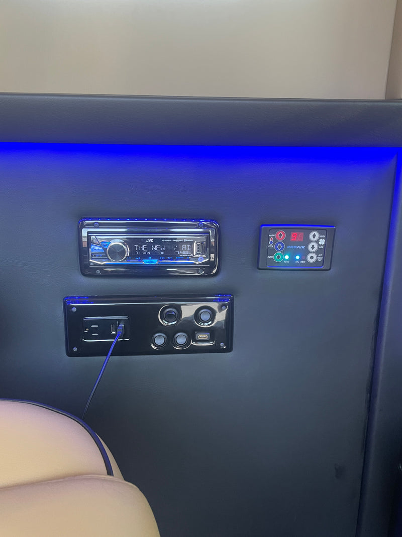 RV rental interior showing a JVC stereo, PROAIR climate control (displaying 98 degrees), and power/USB outlets with blue ambient lighting. — photo 6