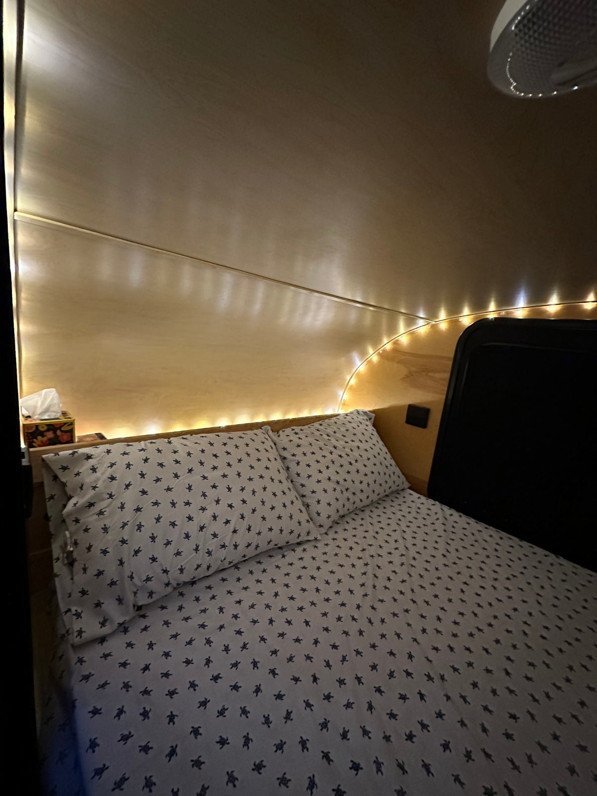  and a portable induction cooktop for camping.|Relax in this RV rental's cozy bed! Features an AC unit — photo 7