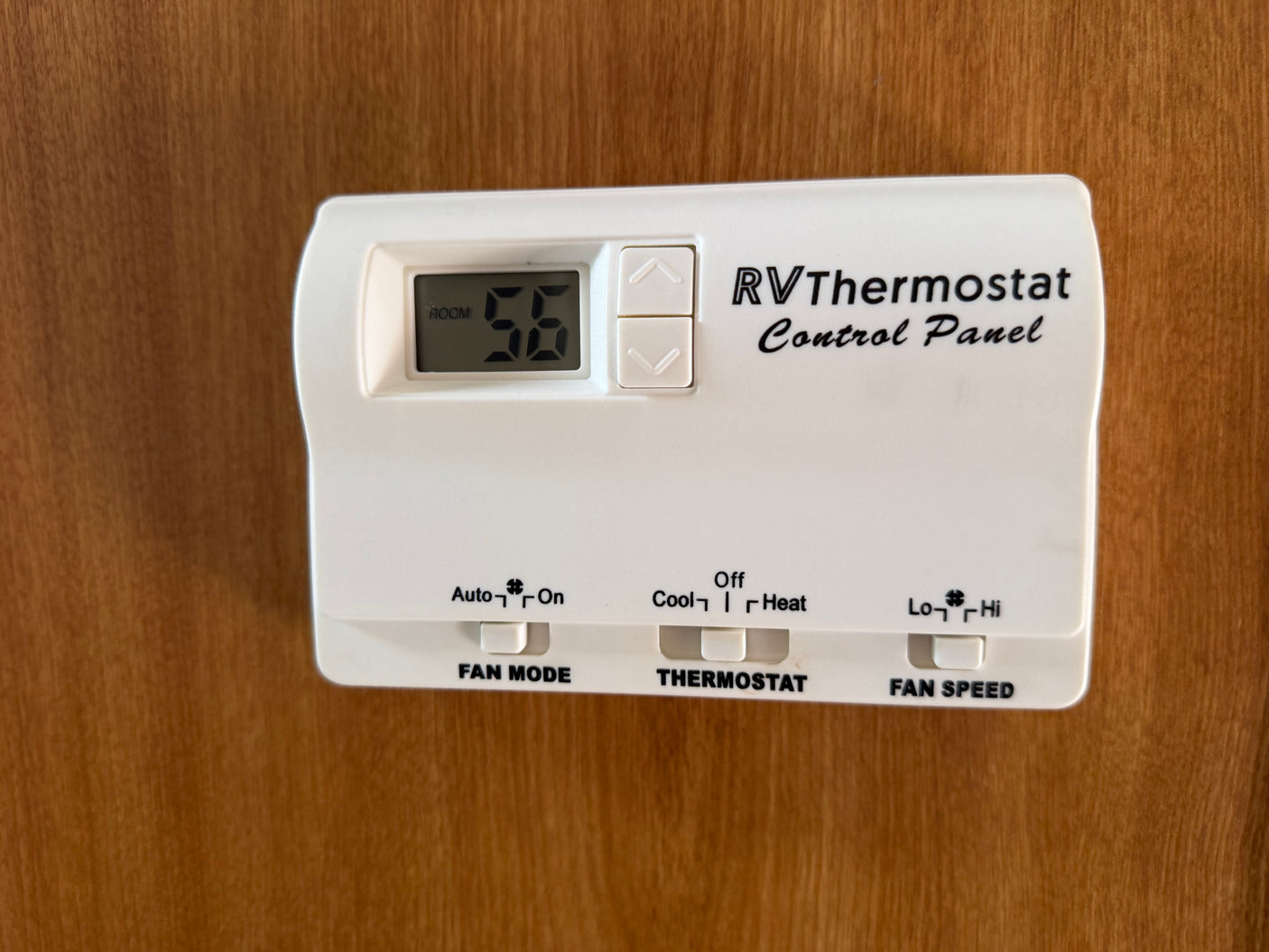 This RV rental's digital thermostat control panel displays room temperature 56, with sliders for fan mode, cool/heat, and fan speed.