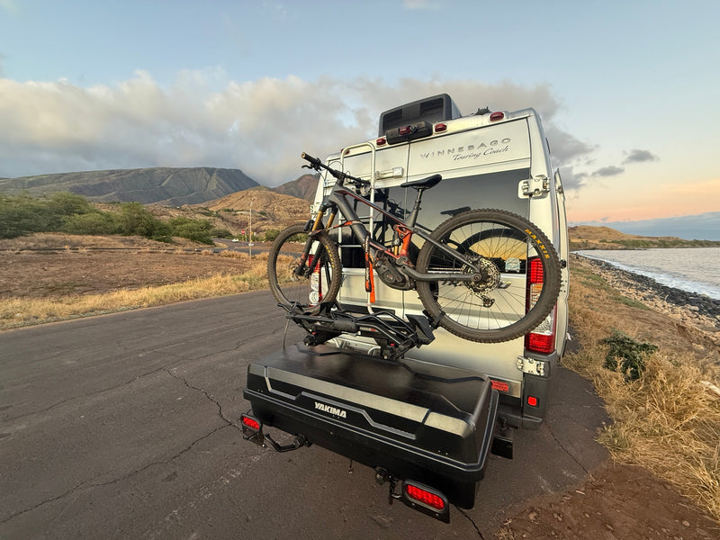 Adventure-ready RV rental, equipped with a mountain bike and cargo box, parked by a scenic coast. — photo 5