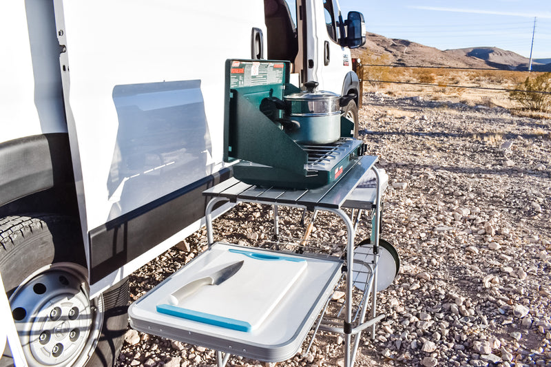 Outdoor kitchen setup next to an RV rental: portable stove, pot, and cutting board in a desert camp. Enjoy cooking! — photo 5