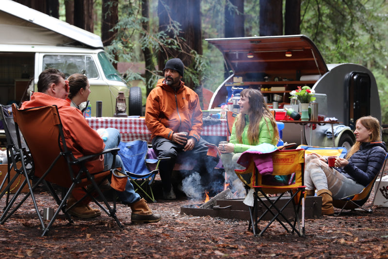 Enjoying a campfire with an RV rental, including a classic camper van and teardrop trailer. — photo 20