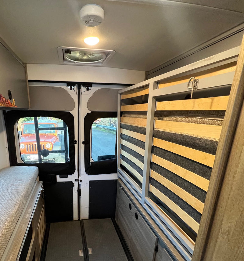  and a fire extinguisher.|Inside an **rv rental**: light-colored rear seating and dinette — photo 11