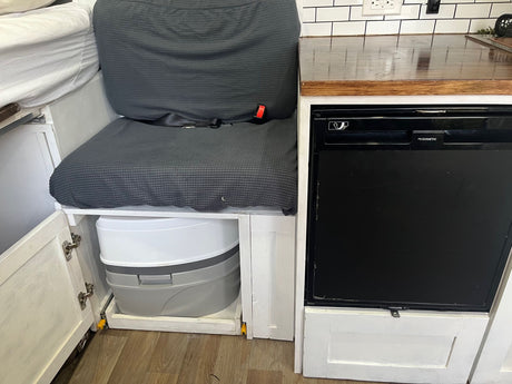 Smart RV rental features: a hidden portable toilet, Dometic fridge, and durable countertop for travelers.