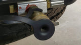 This RV rental image shows a tire with aggressive tread, and a brass valve fitting with a black protective cap on the chassis.