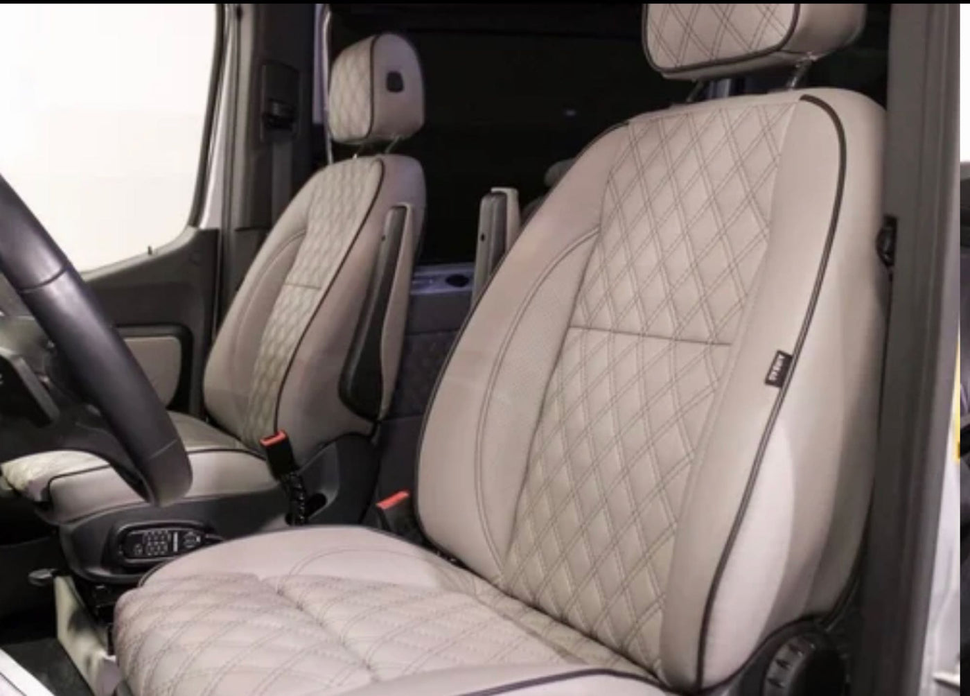 Premium diamond-quilted front seats and spacious cabin details of an RV rental, designed for ultimate comfort. — photo 6