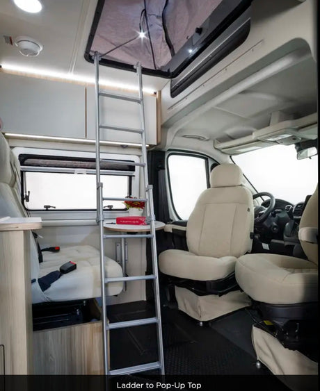RV rental interior: Ladder to pop-up top. This cozy camper van features light seating, windows & overhead storage.