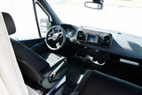 Front cabin view of an RV rental Mercedes Sprinter van, featuring the driver's seat, steering wheel, and dashboard.