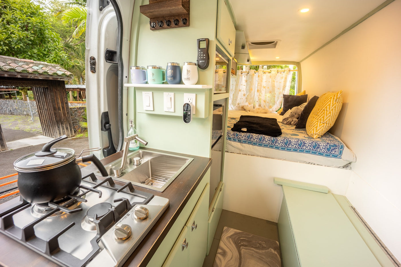 Cozy RV rental interior: fully equipped kitchen, comfy bed, and outdoor views for your next adventure. — photo 6