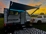 Beautiful sunset scene featuring a Catalina RV, perfect for your next rv rental adventure, parked with a truck and camping setup.