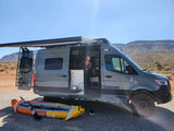 Woman smiles from her grey RV rental