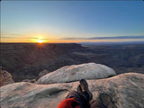 Enjoying a stunning canyon sunrise from a cliff. RV rental makes these scenic nature travel views accessible.