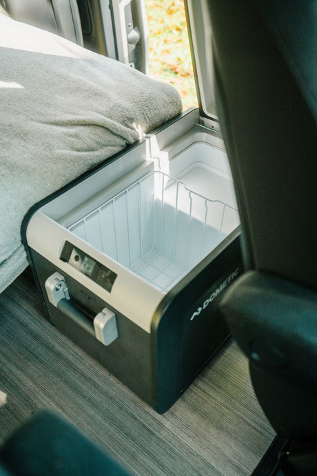 An open Dometic portable fridge/cooler inside an RV rental, ready for provisions on your road trip.