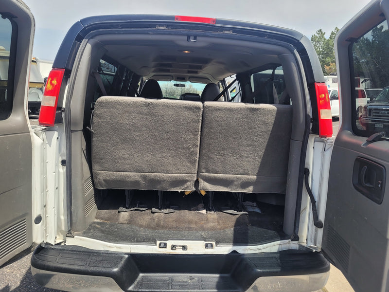 Inside a white van, showing the rear seats & spacious cargo area with doors open, perfect for an RV rental. — photo 5