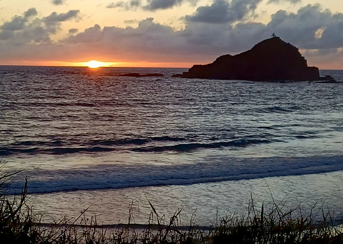 Sunset over a tranquil ocean with a silhouetted island. Plan your next RV rental escape! — photo 2