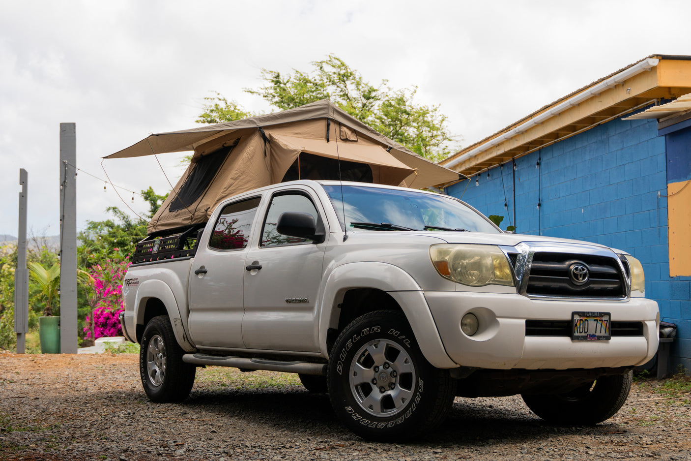 Our white Toyota Tacoma with a rooftop tent is the perfect RV rental for island camping adventures in Kauai.