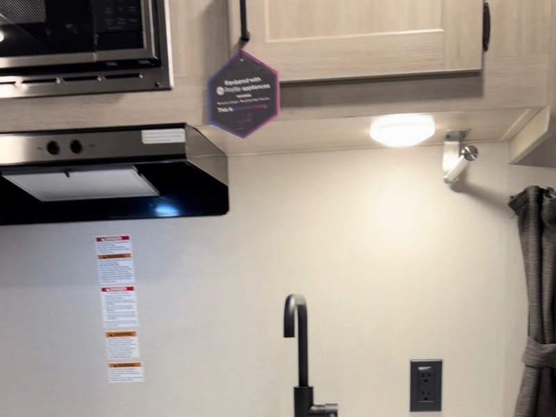  alongside the striped exterior.|RV rental interior: A cozy bedroom with a window — photo 5