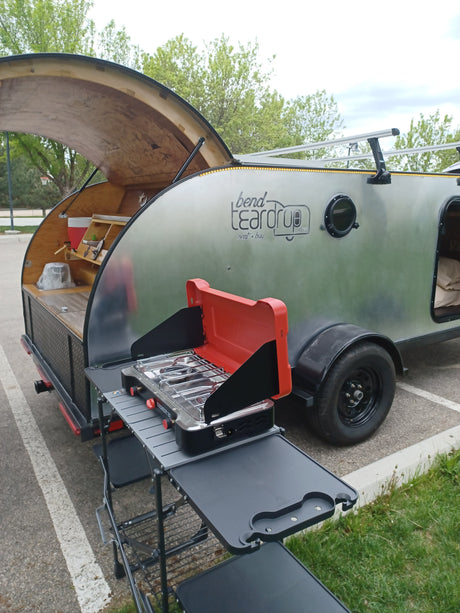 This Bend Teardrop RV rental features an open rear kitchen with a stove setup, ready for outdoor adventures.