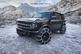 This rugged Ford Bronco SUV, equipped with snow chains for winter adventure, highlights our RV rental options for snowy excursions.